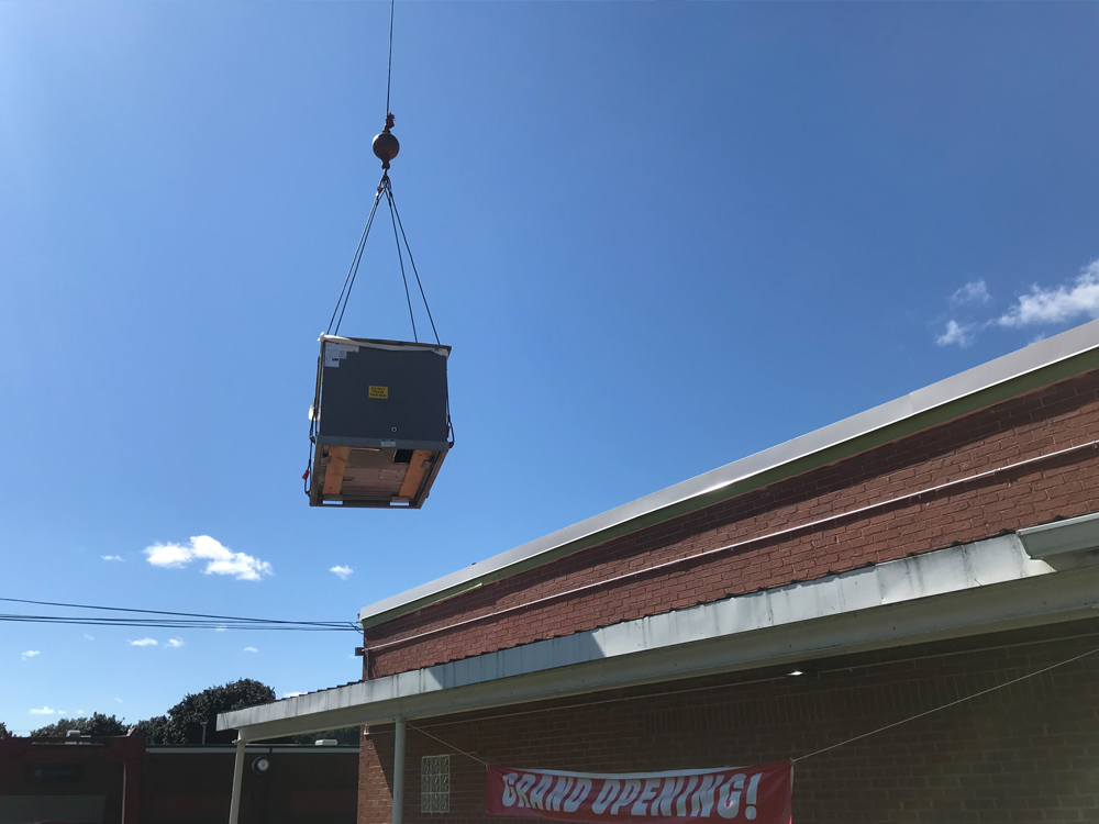 Crane lifting materials on construction site