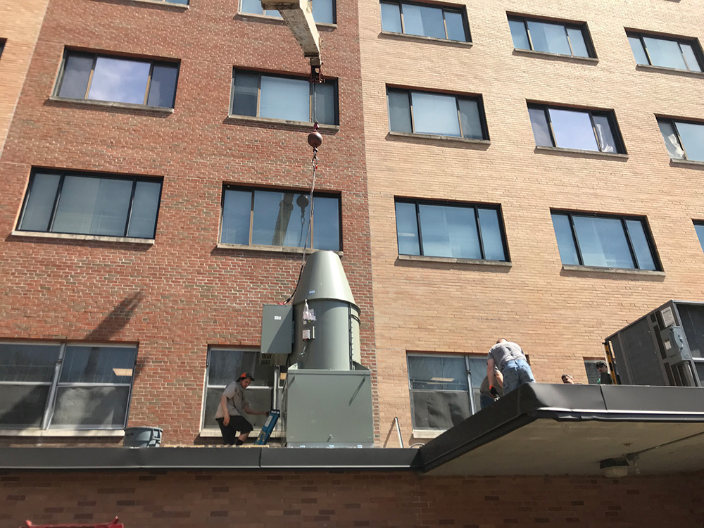 Rooftop top installation of commercial exhaust fan for kitchen at a medical facility in Holyoke