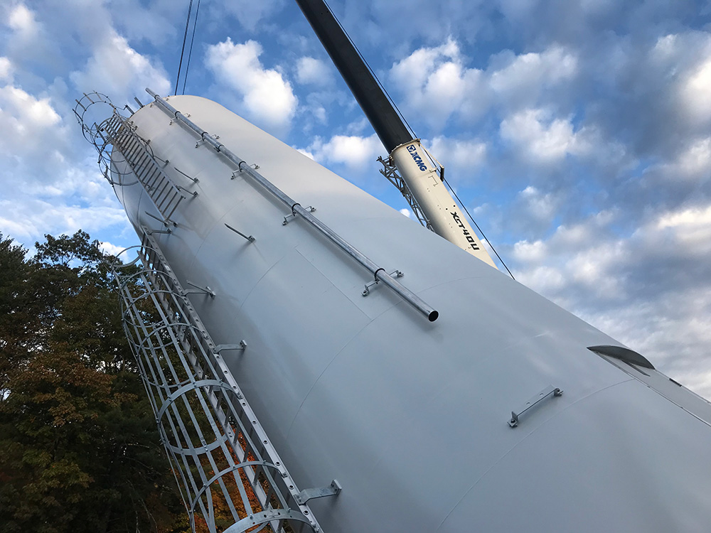 Large storage tank installation, almost complete – our crane is holding the tank while the other operator stands the tank upright